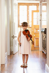 Violin, girl and portrait of child in home for learning, practice or music education. Art, fiddle...