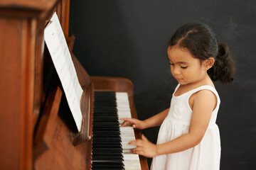 Piano, girl and kid in home for learning, practice and classical education with musical notes....