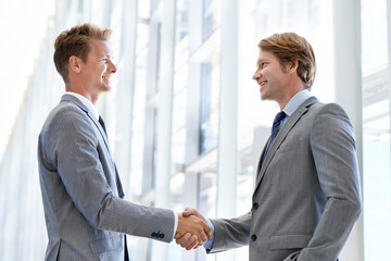 Fototapeta premium Men, colleagues and shaking hands or business agreement or collaboration on project, deal or promotion. Male people, networking and gesture for partnership at law firm or welcome, onboarding or unity