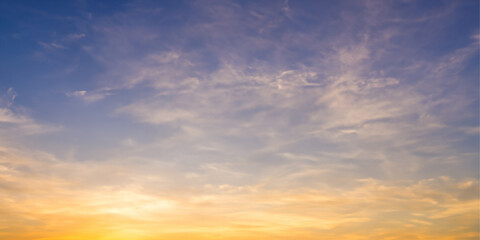 A captivating evening sky adorned with a mix of clouds, showcasing the warm hues of a stunning sunset