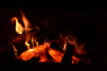 Fototapeta na wymiar Bright burning fire. Sparks of fire