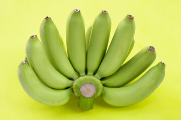 Green banana on green background.