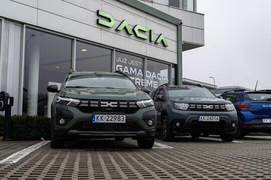 Dacia cars outside dealership building with logo sign. Romanian car manufacturer, automobile company auto salon. Vehicle showroom signage with brand logotype on February 9, 2024 in Krakow, Poland.