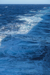 Seascape ocean view from cruiseship cruise ship liner making waves plowing through the sea cruising