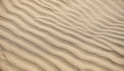 Beautiful Nature Sandy Summer Background. Abstract pattern of wave sand on beach formed by wind. Light Texture of the fine sand Close up. Wallpaper With Copy Space for design