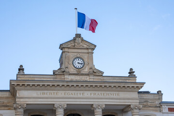 French tricolor flag on mairie text building mean town hall in city center with clock in france