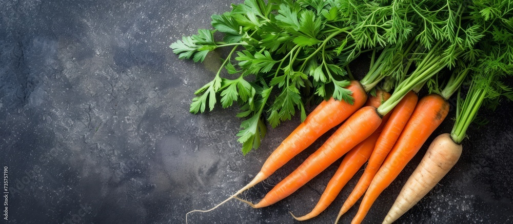 Canvas Prints A bunch of carrots with fresh green leaves, a staple root vegetable in cuisine, sitting on a table as natural food ingredients. Delicious and nutritious!