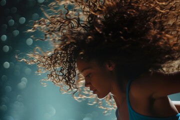 action shot of a dancers curly hair bouncing during a reel