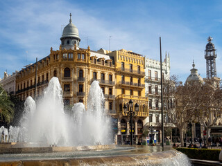 Fototapeta premium Fountain in the town hall square in the background, Noguera House (1909). Valencia, Spain.