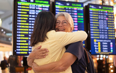 Airport terminal reunion. Travel, friends, family hug in airport, reunion and happiness for international trip, getaway and cheerful. Love, women couple embrace for arrival or departure trip