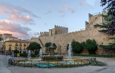 Public fountain in the Adolfo Suarez Square in the city of Avila with the walls in the background. Castile and Leon, Spain.