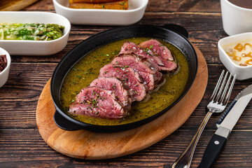 Sliced grilled tenderloin flavored with sauces after being seared on the grill