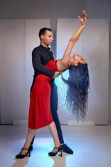 Young caucasian dance couple dancing classical ballroom or tango dance. Choreography concept. Man...