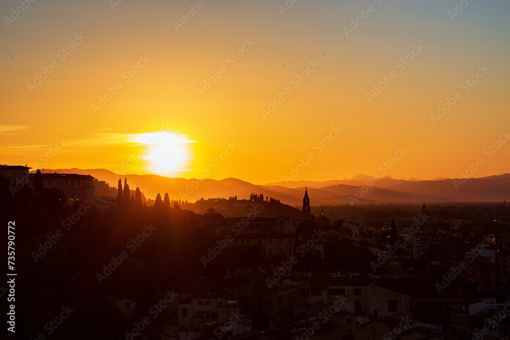 Wall mural Awesome sunset view of a city and the mountains