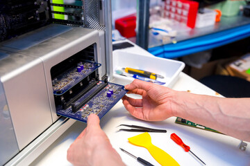 Technician opening the back part of a computer to repair