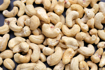 Cashew nuts on dark background.