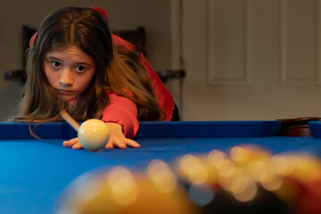 Brown Haired Teen Girl Breaking New Rack of Balls on Blue Pool Table, California, USA, horizontal