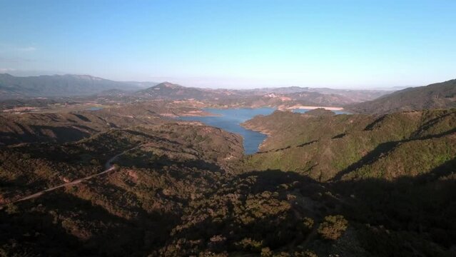 Aerial Scenic View Of Lake Amidst Rock Formations, Drone Flying Backwards On Sunny Day - Santa Barbara, California