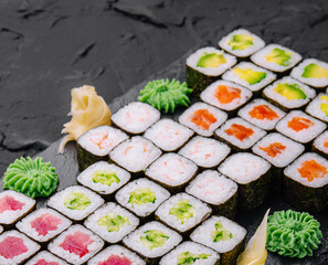 Maki sushi set served on black stone tray