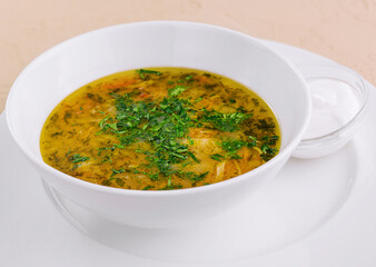 parsley noodle soup on white bowl