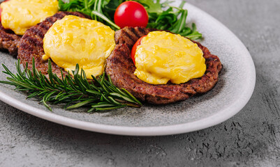 Meatballs or cutlets with tomato and cheese