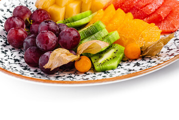 kiwi smoothie with different tropical fruits on a plate