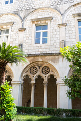 Fototapeta na wymiar Green garden in front of the old Dominican monastery. Dubrovnik, Croatia