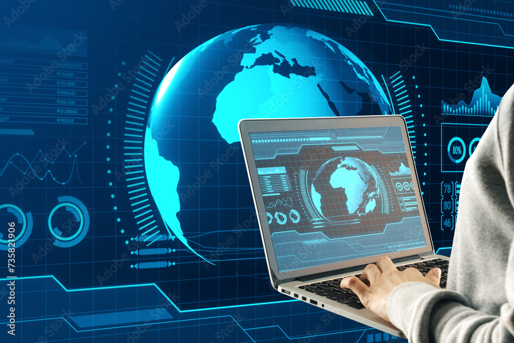 Poster Close up of male hands using laptop with holographic screen with digital globe interface and business chart on blurry blue background. HUD, international stock and future monitor concept.