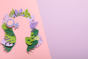 Paper female head with paper decorative leaves