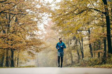Fototapeta premium A fit runner running in nature.