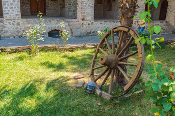 Old cart wheel in garden an ancient caravanserai in the city of Sheki in western Azerbaijan