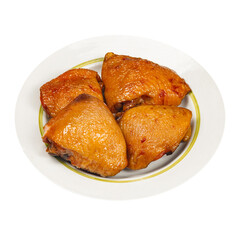 Smoked chicken legs, on a plate on a white background, isolated