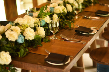 Macro view of a Wooden dinner table cutlery with floral decorations