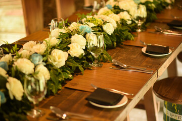 Closer look of a Wooden dinner table cutlery with floral decorations