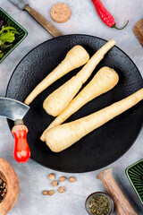 Whole raw parsnip roots.