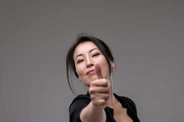 Thumbs-up reflects confidence, satisfaction, positive outcome