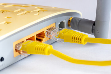 Close-up view of LAN network switch connectors with Ethernet cables attached. Isolated on a white background.