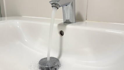 Water tap in washbasin. Bathroom faucet. Water Flowing From Faucet in Bathroom. Sink Water flowing...