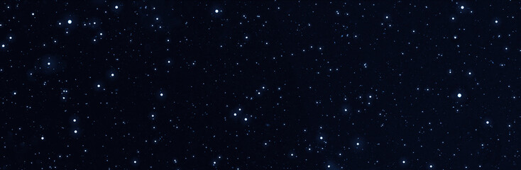 Fototapeta premium Panoramic starry night sky. Galaxy space background. Glowing stars in space. New Year, Christmas and celebration banner background concept.