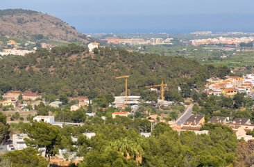 Villa in mountains. Mountains landscape with houses on hill. Towhouse and Home on hills. House in mountains. Rural landscape with hills. Houses on Mountain with nature scenery in Gilet Town in Spain.