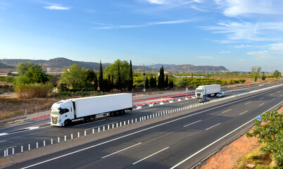 Freight shipping by truck. Semi truck with Semi-trailer driving along highway. Goods Delivery by...