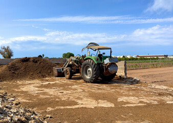 Farmer tractor on the farm. Agricultural tractor on the farmer field. Spain olive farm