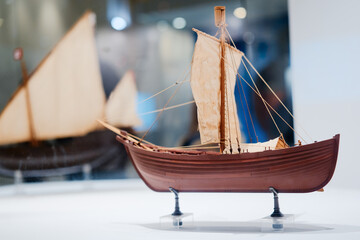The small model of historical ancient ship in marine museum.