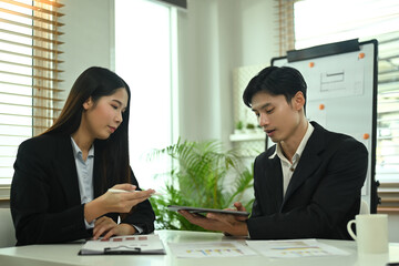 Young businesspeople working on investment and marketing projects at co working space