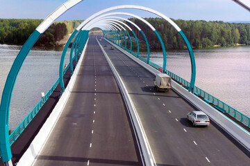 Modern arched road bridge over the river