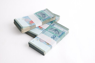 Stack of RM50 Ringgit Malaysia on white background. Selective focus.