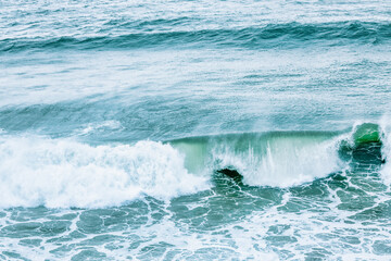 Fototapeta premium Wave splashing close-up. Crystal clear sea water, in the ocean in San Francisco Bay, blue water, pastel colors.