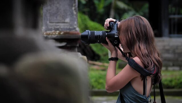 High definition slow motion footage of woman photographer at Balinese temple, Bali, Indonesia.
Medium angle, parallax movement.
