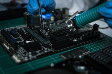 Fototapeta na wymiar Hands repairing electronic devices. Electronic technician.