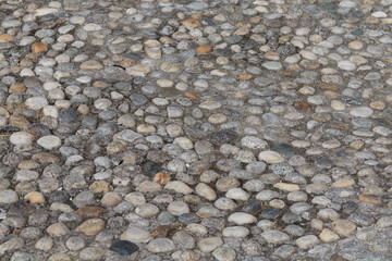Round stones in the ground - 735876587